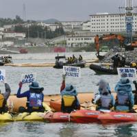 Demonstrators protest from canoes off Henoko in Nago, Okinawa Prefecture, on Wednesday. | KYODO