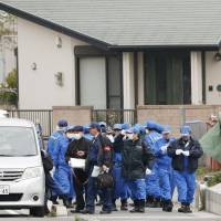 Police investigate the scene of a triple-murder at a house in Hioki, Kagoshima Prefecture, on Friday. | KYODO