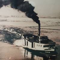 A photo at the Yodogawa Museum in Hirakata, Osaka Prefecture, shows old ships in the late 1800s that brought passengers upriver from Osaka to Kyoto\'s Fushimi in a journey that could take at least eight hours. Today, a train makes the same journey in about 30 minutes. | ERIC JOHNSTON
