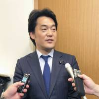 Hiroyuki Konishi, an Upper House lawmaker and member of the Democratic Party, speaks to reporters on Tuesday in the Diet. | KYODO