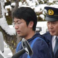Yasutaka Tsurumoto, a former NHK reporter accused of raping three women, leaves a police station in Yamagata Prefecture in February 2017. Prosecutors on Wednesday demanded he be sentenced to a 24-year prison term. | KYODO