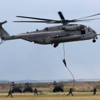 Troops from the Ground Self-Defense Force\'s Amphibious Rapid Deployment Brigade, Japan\'s first marine unit since World War II, take part in a joint drill with U.S. Marines at the GSDF\'s Camp Ainoura in Sasebo, Nagasaki Prefecture, on Saturday. | REUTERS