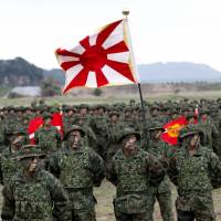 Troops from the Ground Self-Defense Force\'s Amphibious Rapid Deployment Brigade, Japan\'s first marine unit since World War II, gather at a kickoff ceremony at the GSDF\'s Camp Ainoura in Sasebo, Nagasaki Prefecture, on Saturday. | REUTERS
