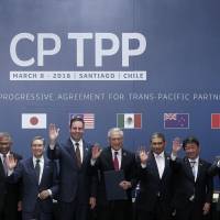 Leaders pose for an official photo  after signing the rebranded 11-nation trade pact, the  Comprehensive and Progressive Agreement for Trans-Pacific Partnership (CPTPP), in Santiago on March 8. | AFP-JIJI