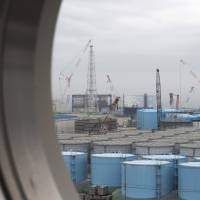 Storage tanks for contaminated water stand at the Fukushima No. 1 nuclear plant in February 2017. More than seven years after the world\'s worst nuclear accident since Chernobyl, Tepco still faces massive compensation lawsuits filed by people whose livelihoods were destroyed. | BLOOMBERG