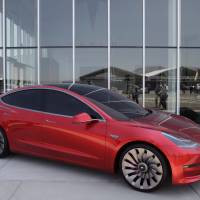 A Tesla Motor Inc. Model 3 vehicle is displayed outside the company\'s Gigafactory in Sparks, Nevada, on July 26, 2016, the day Tesla officially opened the facility in partnership with leading lithium-ion battery maker Panasonic. The factory is about 30 percent complete, but when it\'s finished it will be about about the size of 262 NFL football fields. | BLOOMBERG