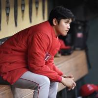 The Angels\' Shohei Ohtani sits in the dugout before his start against the Astros in Houston on April 24. | AP