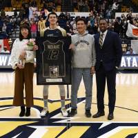 George Washington University senior star Yuta Watanabe, joined by his parents Kumi and Hideyuki and coach Maurice Joseph, was honored before the team\'s final home game of the 2017-18 season on Feb. 28. | GW ATHLETICS