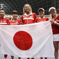 Japan\'s Fed Cup team celebrates after beating Britain in a playoff to secure a return to the competition\'s top level on Sunday in Miki, Hyogo Prefecture. | KYODO