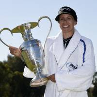 Pernilla Lindberg poses with the championship trophy after winning the ANA Inspiration in an eight-hole playoff on Monday at Mission Hills Country Club. | KYODO