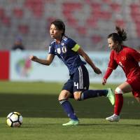 Japan’s Saki Kumagai controls the ball ahead of Vietnam’s Nguyen Thi Lieu during their match on Saturday in Amman. | AP
