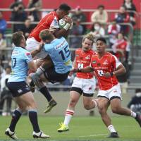 Waratahs\' Bryce Hegarty tackles the Sunwolves\' Semisi Masirewa in Super Rugby action on Saturday in Tokyo. | AP
