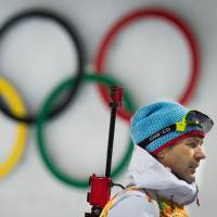 Norwegian biathlon star Ole Einar Bjoerndalen walks past the Olympic rings at the 2014 Sochi Winter Games. | AFP-JIJI