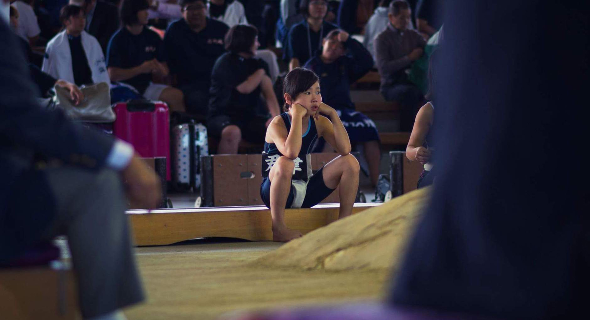 A girl sits beside the ring at the women's national sumo championships in Sakai, Osaka Prefecture, in October 2016. | INSIDE SPORT JAPAN