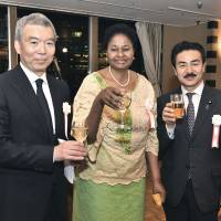 Namibian Ambassador Sophia-Namupa Nangombe (center) poses for a photograph with Masato Saito (left), Namibia\'s honorary consul, and State Minister for Foreign Affairs Masahisa Sato during a reception to celebrate the country\'s national day at the Foreign Correspondents\' Club of Japan on March 22. | YOSHIAKI MIURA