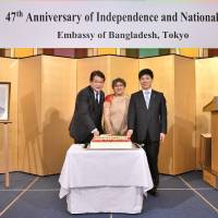 Bangladesh Ambassadsor Rabab Fatima (center) poses for a photo with Ichiro Tsukada (left), secretary-general of the Japan-Bangladesh Parliamentary Friendship League, and State Minister for Foreign Affairs Kazuyuki Nakane during a ceremony to celebrate the country\'s national day at Hotel Okura Tokyo on March 26. | YOSHIAKI MIURA