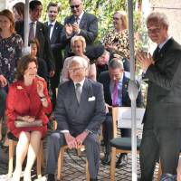 Swedish King Carl XVI Gustaf (center) and Queen Silvia (left) sits near Swedish Ambassador to Japan Magnus Robach (right) at an event to mark 150 years of diplomatic relations between Sweden and Japan at the embassy on April 22. | YOSHIAKI MIURA
