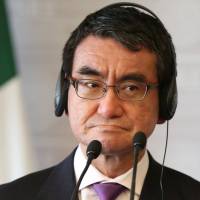 Foreign Minister Taro Kono listens to his Mexican counterpart, Luis Videgaray, while delivering a joint message in Mexico City on May 24. Japan is considering arranging a meeting between Kono and his North Korean opposite, Ri Yong Ho, in Singapore in early August. | REUTERS