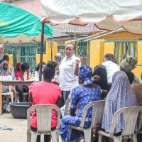 Nkem Okocha (center) leads Mamamoni, a group that helps empower impoverished women by teaching them new skills and microfinancing their businesses. | SOLOMON ADETOKUNBO