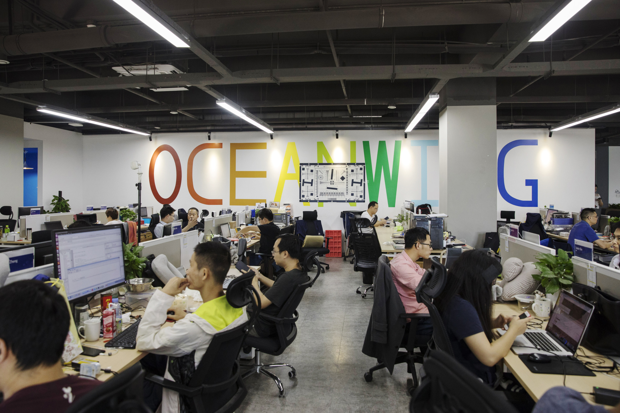 Employees work at the head office of Anker Innovations in Shenzhen, China. | BLOOMBERG