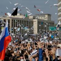 People release paper planes, sa ymbol of the Telegram messenger app, during a rally in protest over a court decision to block the messenger because it violated Russian regulations, in Moscow Monday. | REUTERS