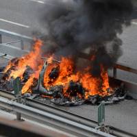 An electric-powered Tesla car burns after a crash on the Swiss A2 motorway on Monte Ceneri near Bellinzona, Switzerland, May 10. | REUTERS