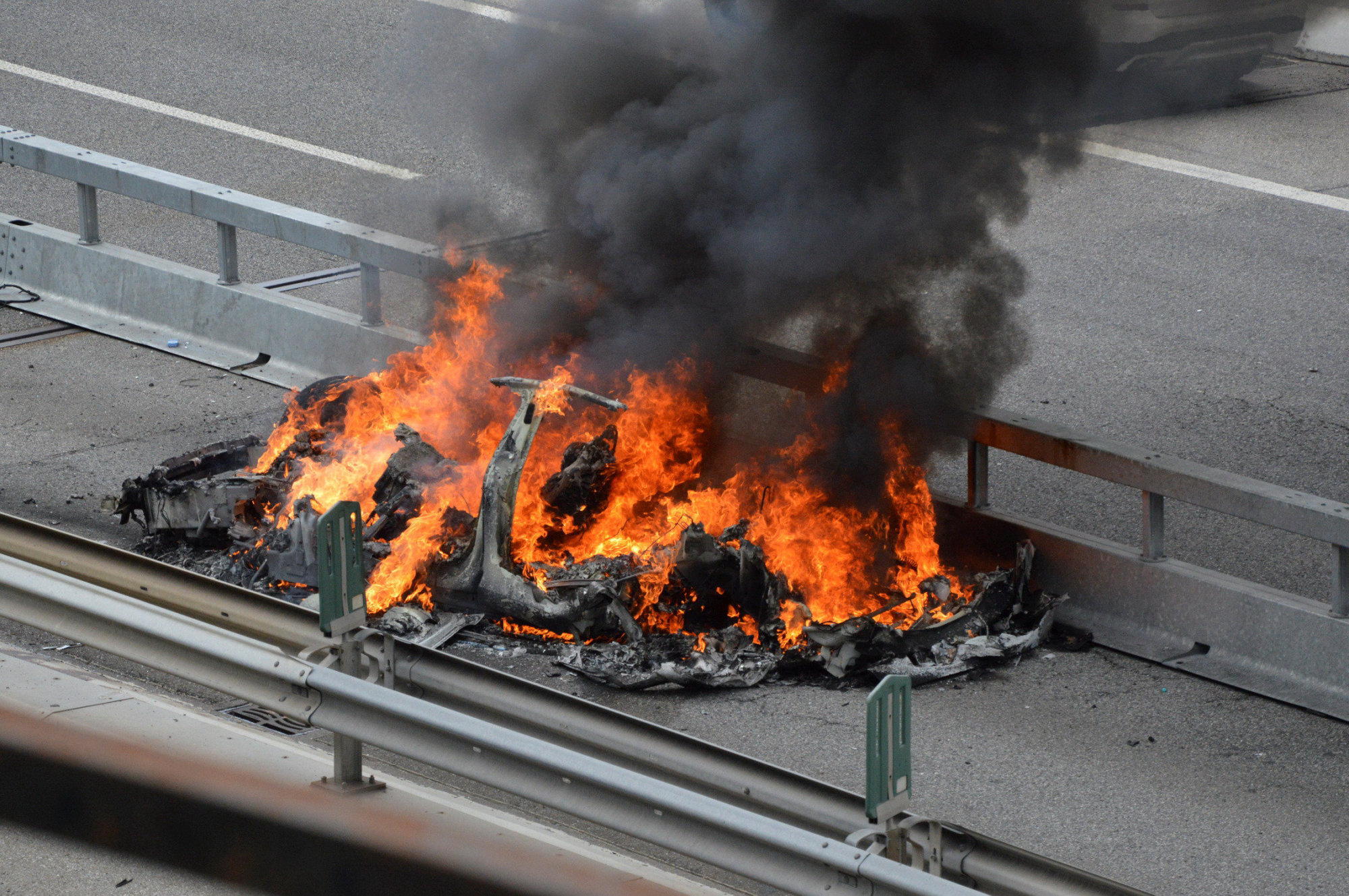 An electric-powered Tesla car burns after a crash on the Swiss A2 motorway on Monte Ceneri near Bellinzona, Switzerland, May 10. | REUTERS