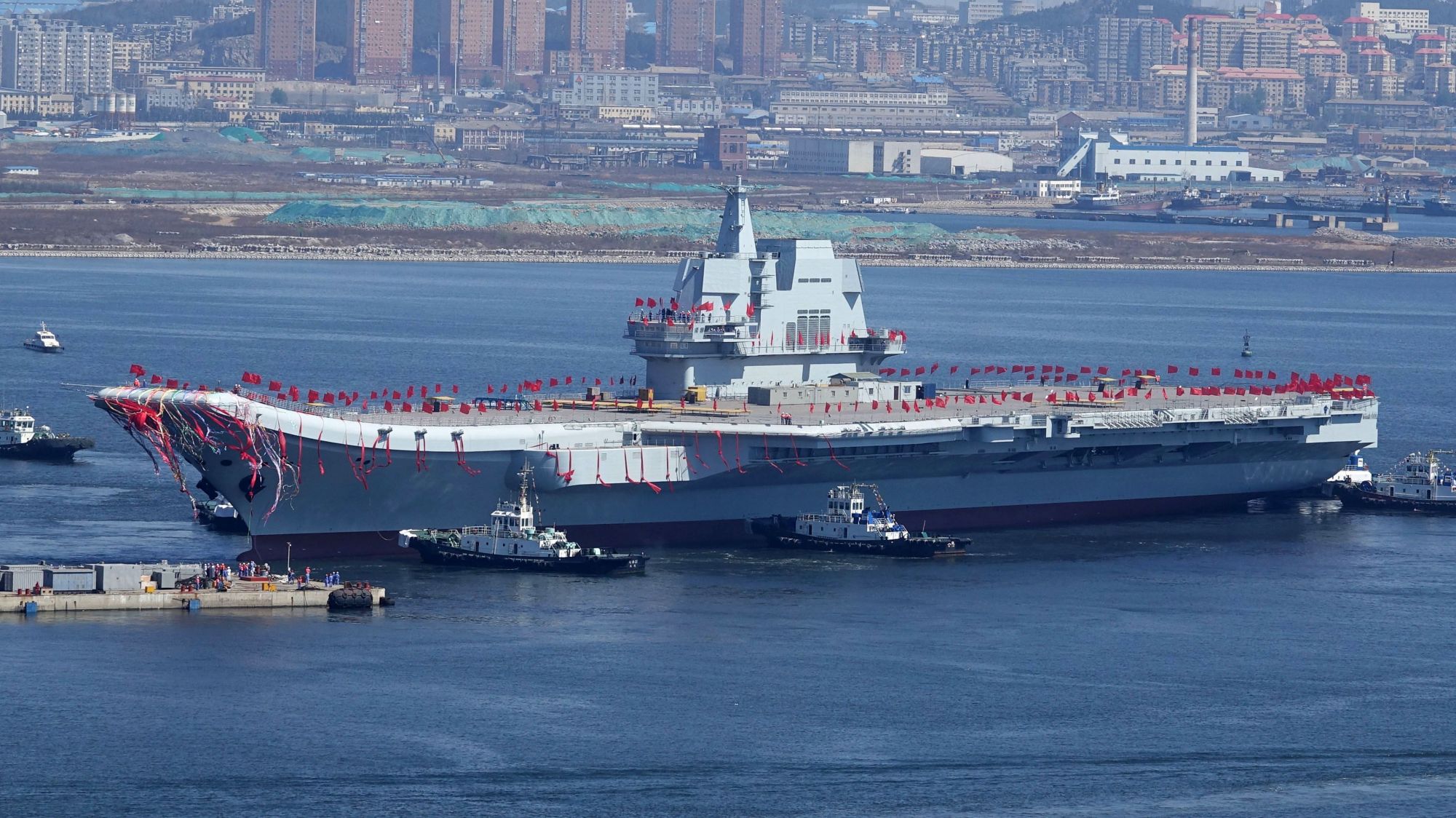 The 'Type 001A,' China's second aircraft carrier &#8212; and first indigenously built &#8212; is seen being transferred from a dry dock into the water at a shipyard in Dalian, in northeastern China's Liaoning province, on April 26. | AFP-JIJI