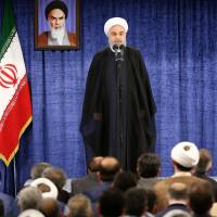 Iranian President Hassan Rouhani (left) speaks as Supreme Leader Ali Khamenei listens during a meeting with members of the government in Tehran on Wednesday. | AFP-JIJI