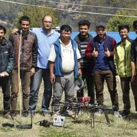 Nepali engineers pose beside their drone used to supply medicine to remote villages in Myagdi on April 9. | KAMAL PUN