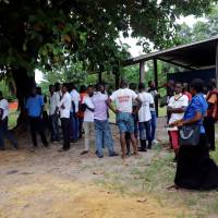 Residents gather near a safety ribbon in the area  prepared to receive suspected Ebola cases, at the Mbandaka General Hospital, in Mbandaka, Democratic Republic of Congo, Sunday. | REUTERS