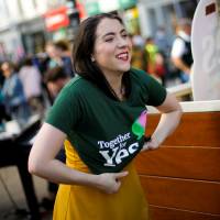 A woman puts on a pro-repeal T-shirt in Dublin on Friday. | REUTERS