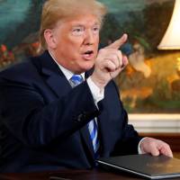 U.S. President Donald Trump speaks to reporters after signing a proclamation declaring his intention to withdraw from the Iran nuclear agreement in the Diplomatic Room of the White House on Tuesday. | REUTERS
