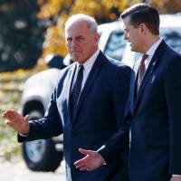 White House Chief of Staff John Kelly (left) walks with then-White House staff secretary Rob Porter to board Marine One on the South Lawn of the White House in Washington last November. | AP