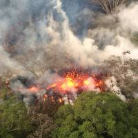 Lava spatters from an area between active Fissures 16 and 20 on Wednesday morning on the lower east rift of the Kilauea volcano near Pahoa, Hawaii. | AP