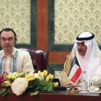 Philippine Foreign Secretary Alan Peter Cayetano and Kuwaiti Deputy Prime Minister and Foreign Minister Sheikh Sabah al-Khaled al-Hamad al-Sabah hold a news conference in Kuwait City on Friday. | AP