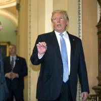 President Donald Trump, with Senate Majority Leader Mitch McConnell, R-Ky. (left), updates reporters on the condition of first lady Melania Trump as they walk to a closed-door meeting with Senate Republicans at the Capitol in Washington Tuesday. | AP