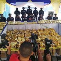 Malaysian Customs officials display 1,187 kg of seized methamphetamine worth some 71 million ringgit (&#36;18 million) during a news conference in Nilai, Malaysia, on Monday. | REUTERS