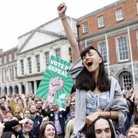 \"Yes\" campaigners celebrate the passage of a referendum paving the way for legalized abortions in Dublin on Saturday. | AP