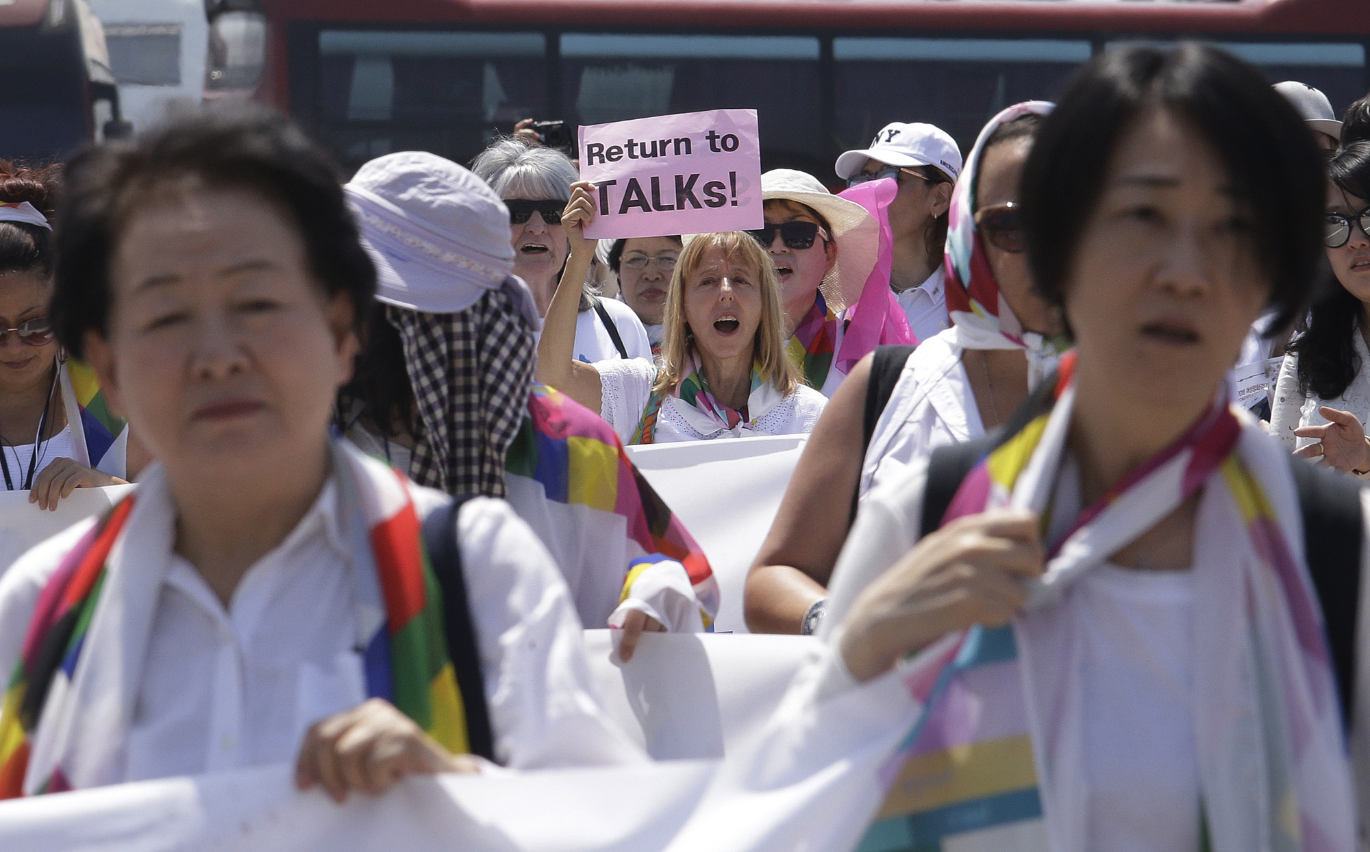 Female activists march toward the Unification Bridge, which leads to the border village of Panmunjom in the Demilitarized Zone, during the 2018 DMZ Women Peace Walk in Paju, South Korea, on Saturday. | AP
