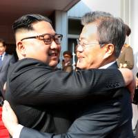 South Korean President Moon Jae-in bids fairwell to North Korean leader Kim Jong Un as he leaves after their summit at the truce village of Panmunjom, North Korea, in this handout picture from the Presidential Blue House on May 26. | REUTERS