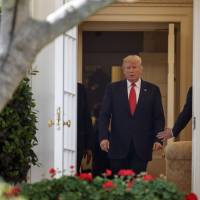 President Donald Trump walks through the Oval Office an his way to a news conference in the Rose Garden of the White House in Washington Monday. | AP