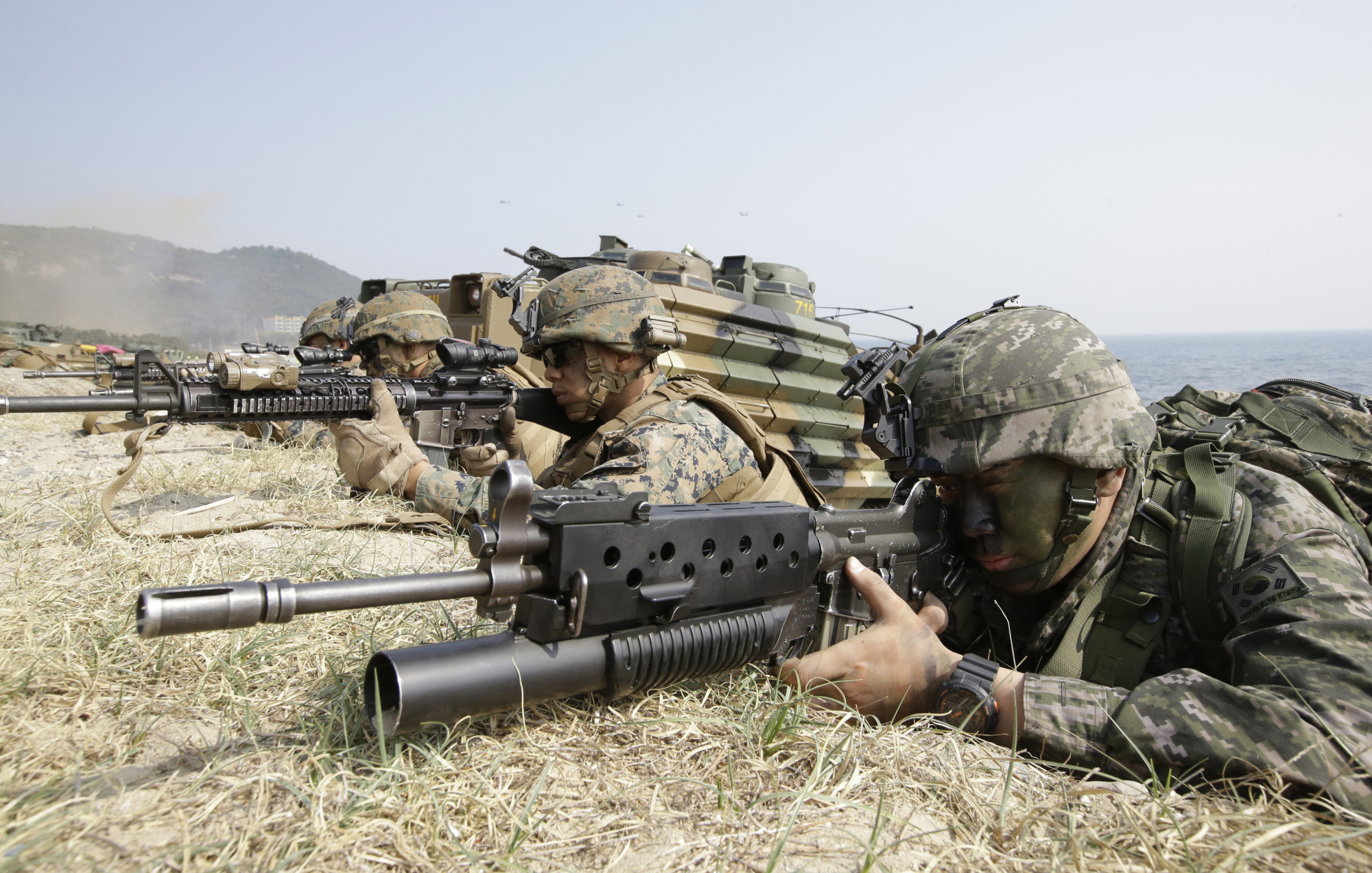 South Korean and U.S. Marines aim their weapons near amphibious assault vehicles during joint U.S.-South Korea military exercises in Pohang, South Korea, in March 2015. | AP
