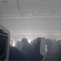 Smoke is seen in the cabin of an All Nippon Airways plane at around 9:45 a.m. Monday at Narita airport. | COURTESY OF A PASSENGER / VIA KYODO