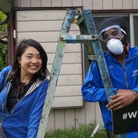 Sayaka Watanabe (right) cleans up a \"share house\" with an asylum-seeker from Angola in Oami, Chiba Prefecture, on April 14. | CHISATO TANAKA