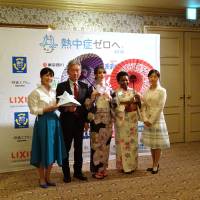 Officials at the Japan Weather Association are seen Tuesday in Tokyo following the announcement of the Heatstroke Zero campaign, aimed at raising awareness of the risks among foreign travelers. | SAKURA MURAKAMI