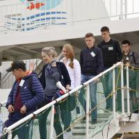 Russian residents of disputed islands off Hokkaido arrive Thursday in Nemuro port on a visa-free trip. | KYODO