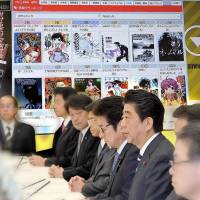 Prime Minister Shinzo Abe and government officials discuss measures in April to counter Mangamura and other websites accused of pirating anime and manga. | KYODO