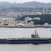 The nuclear-powered USS Ronald Reagan aircraft carrier leaves its home port in Yokosuka, Kanagawa Prefecture, on Tuesday for a long-term patrol in the region. | KYODO