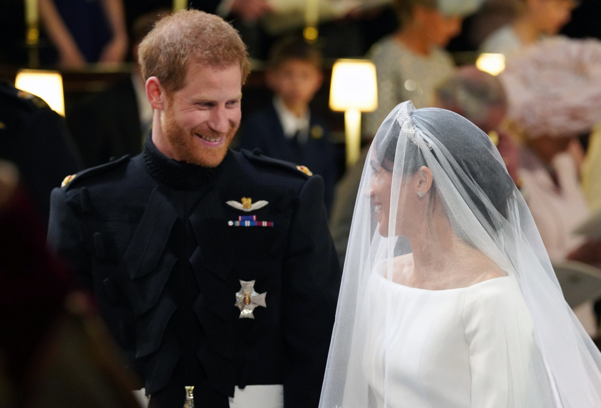 Britain’s Prince Harry looks at his bride, Meghan Markle of the United States, during their wedding ceremony at St. George’s Chapel in Windsor Castle in Windsor, near London, on Saturday. | AP